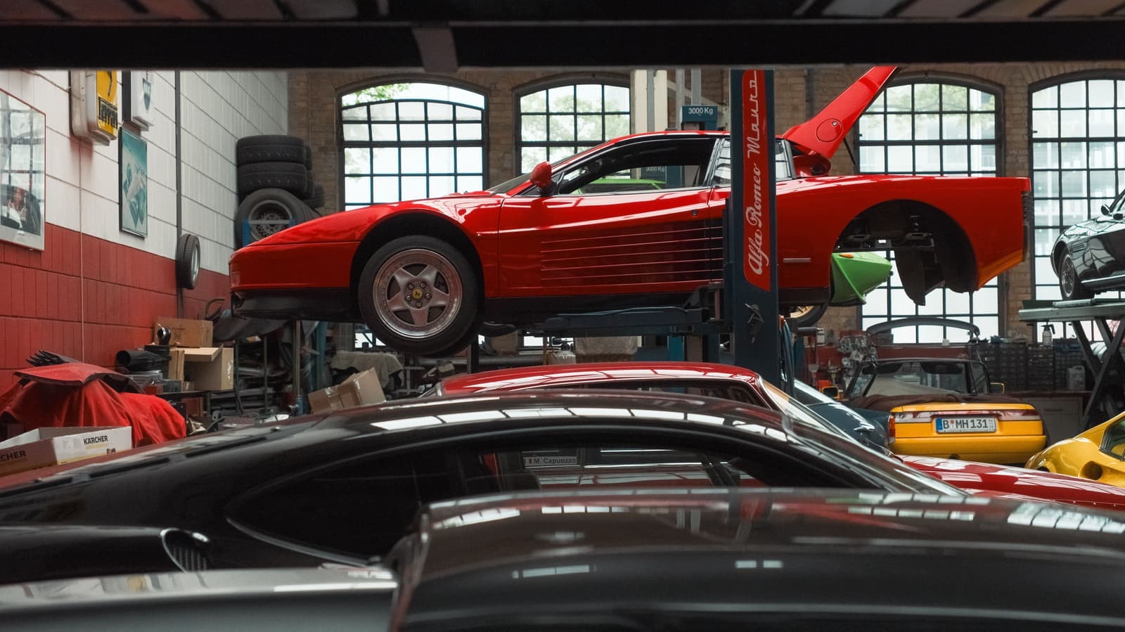 Classic sports car raised on a lift in a workshop