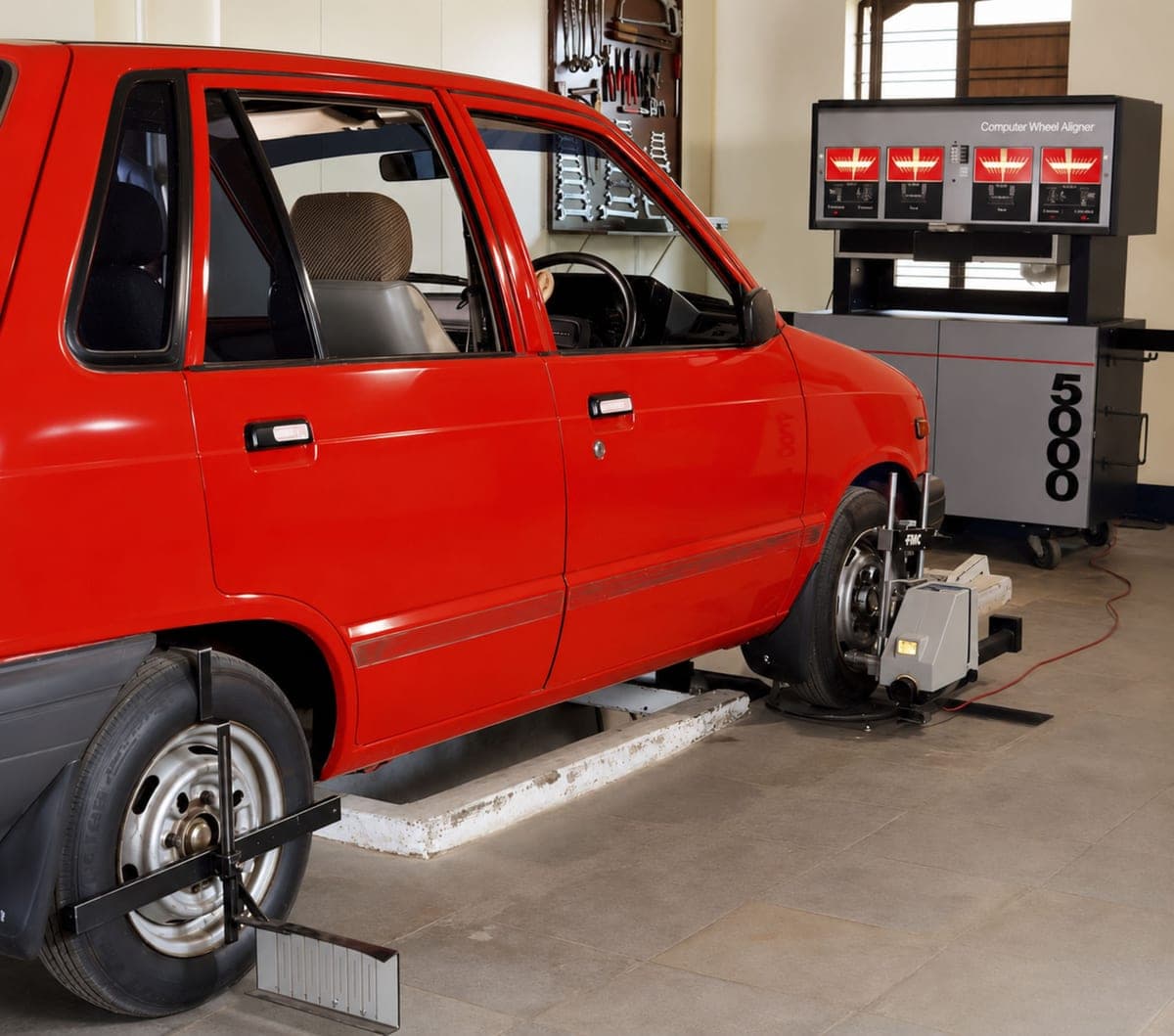 Car on a computerised wheel alignment rig in a workshop