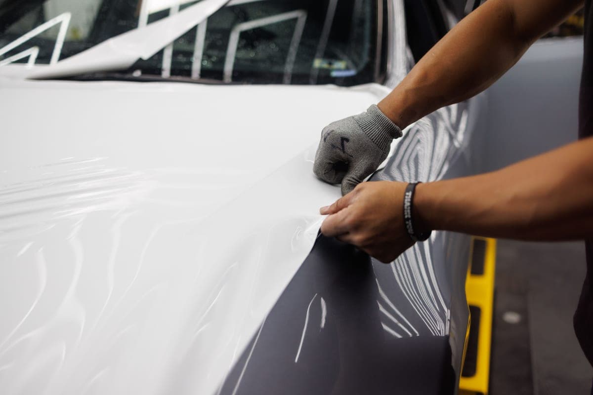 Vinyl graphics being applied to a car bonnet